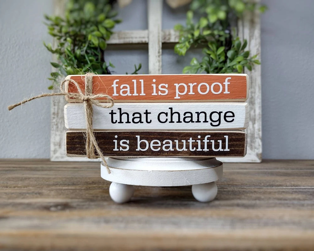 a sign that is sitting on a wooden bench 