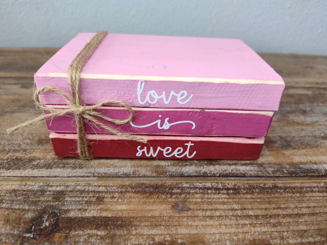 a pink pink cake sitting on top of a wooden box 