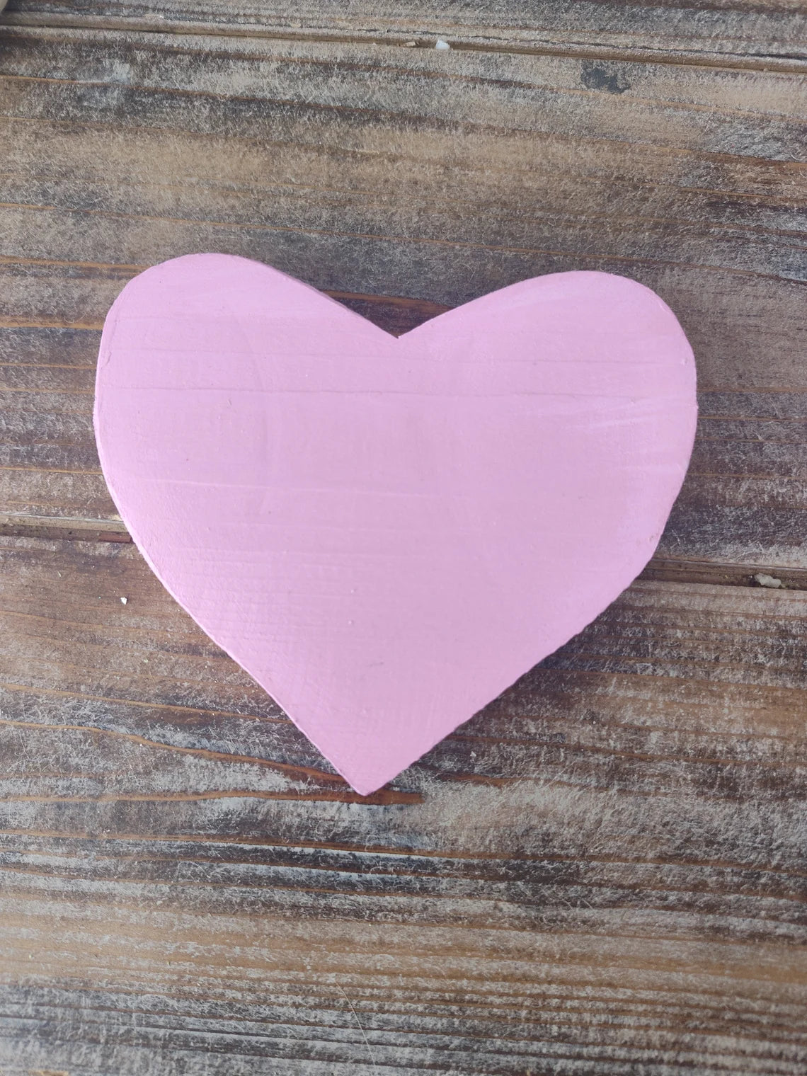 a pink pink umbrella sitting on top of a wooden floor 